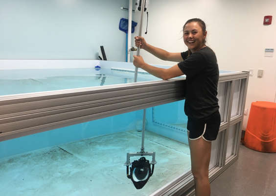 Maddison Pickett, MIT UROP student about to test pole camera within the research tank at MIT Sea Grant